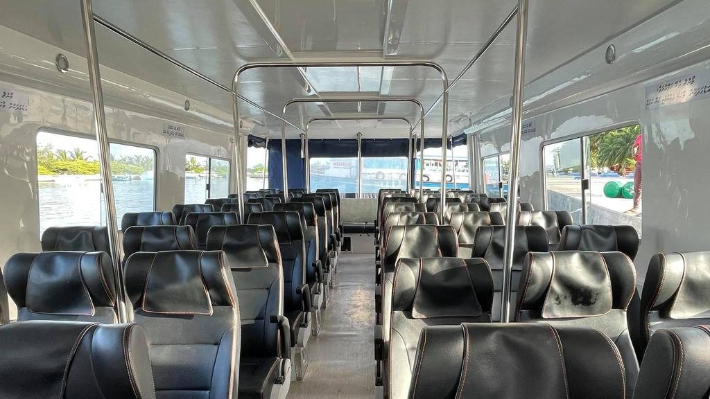 Inside the Coral speedboat: rows of seats along the cabin, windows on both sides.